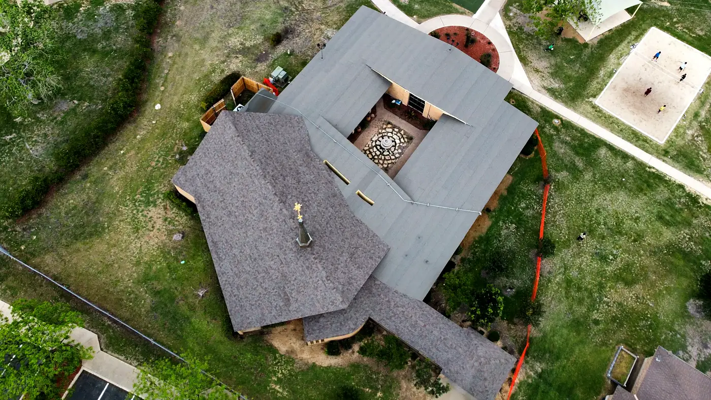 Aerial view of a completed Silver Horn Roofing commercial roof replacement with architectural shingles and low-slope roofing around a courtyard